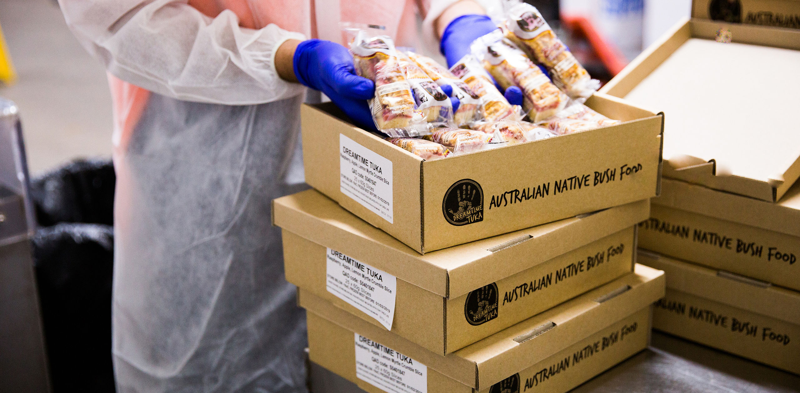 An employee packages boxes of Dreamtime Tucker slice.