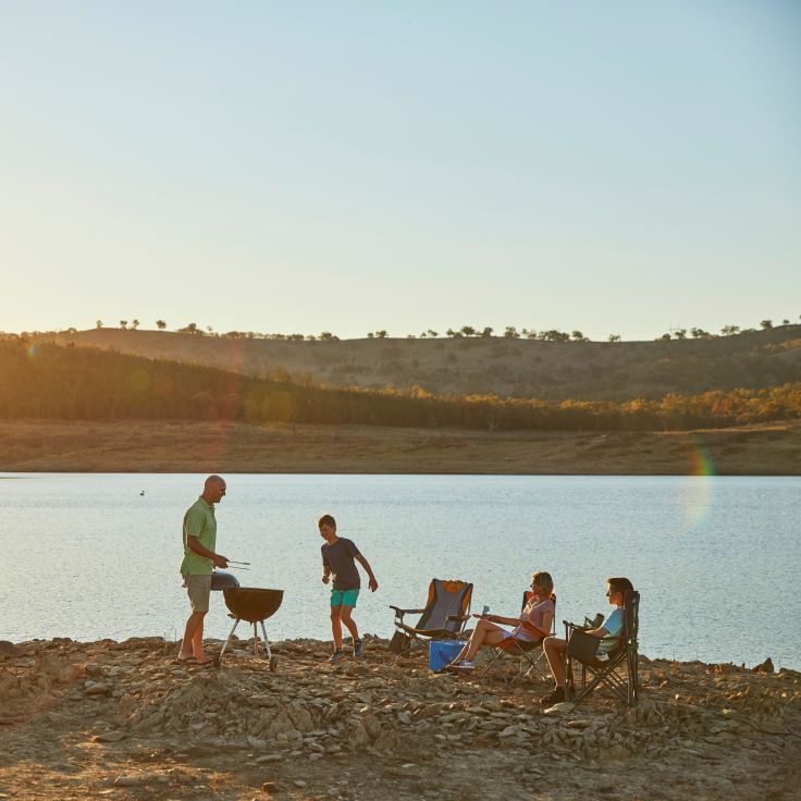 Family enjoying a BBQ on the shore of Lake Burrendong near Mumbil